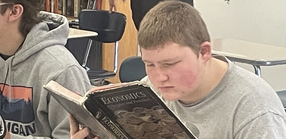 Student Reading Economics Book